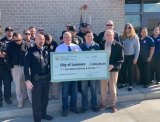 Assemblyman Rudy Salas presents $2 million to Lemoore city officials Tuesday morning (Oct. 26) outside the new dispatch center. He is joined by city officials and police officers.
